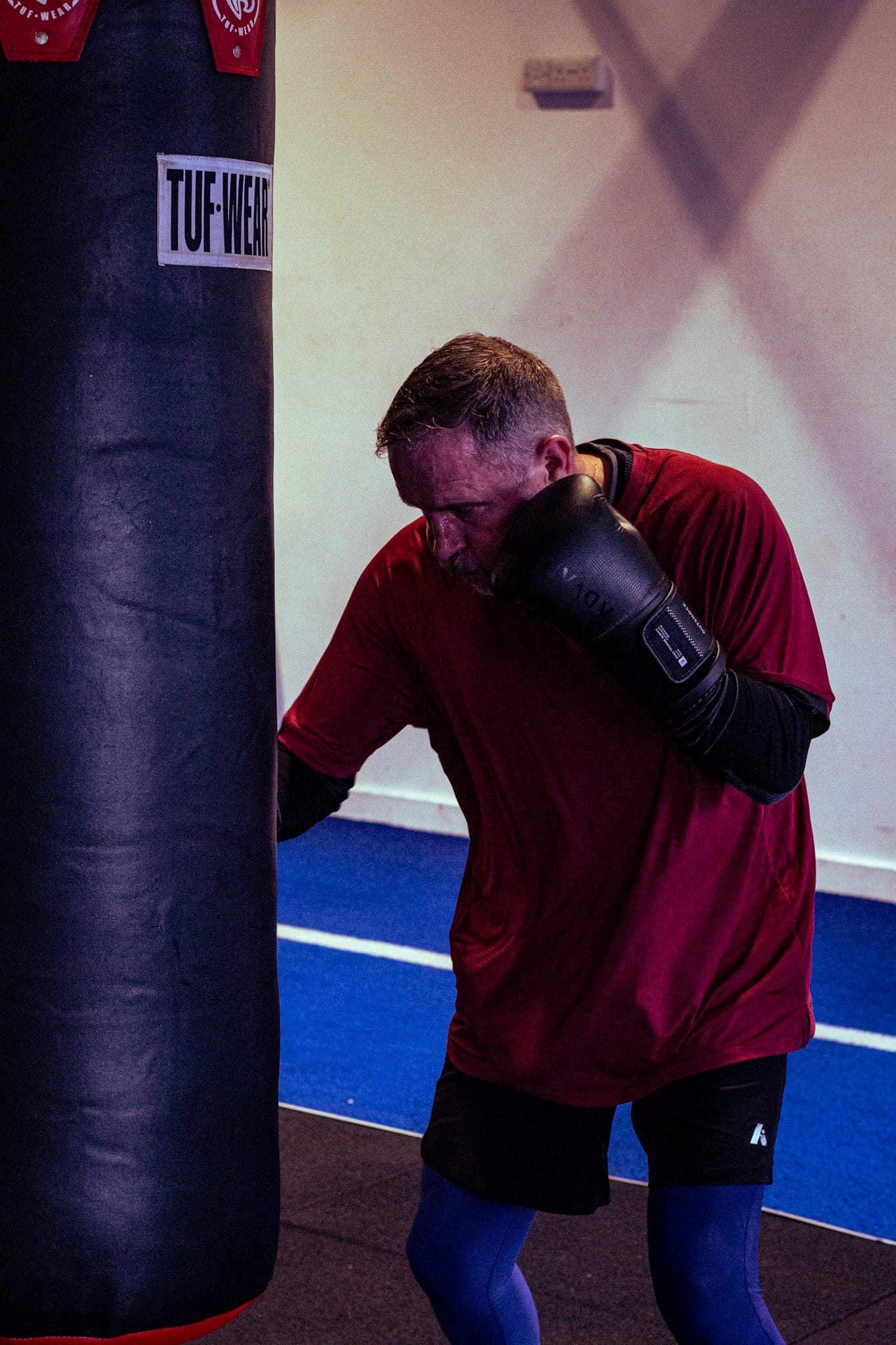 A member throwing a punch on the heavy bag