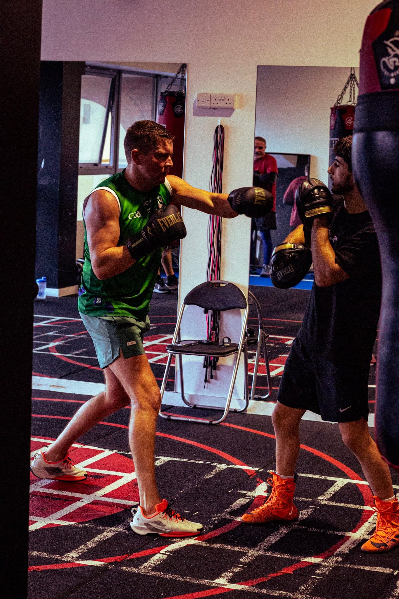 Two members practising boxing combinations on the gym floor