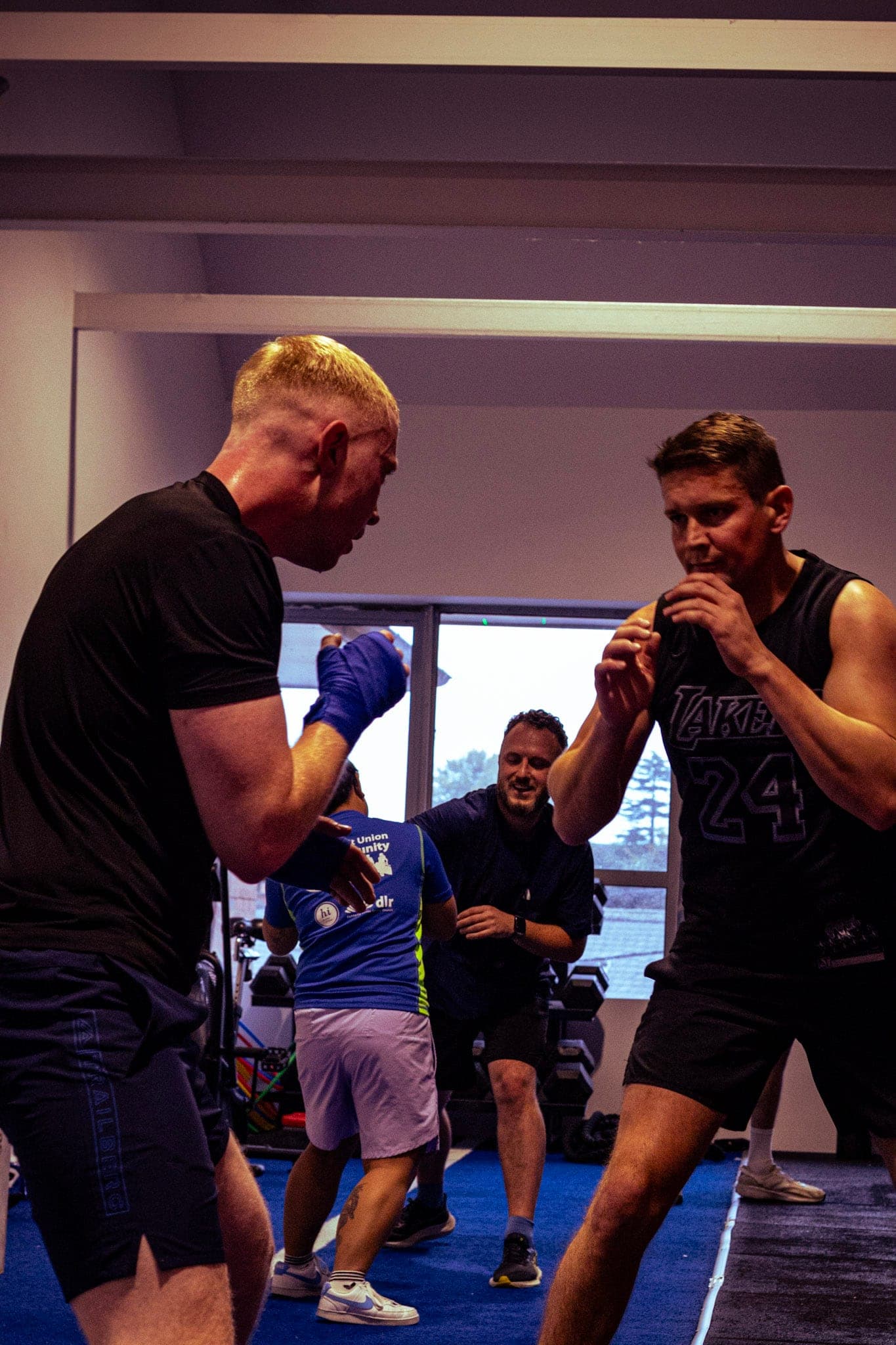 Two members practising boxing drills in class