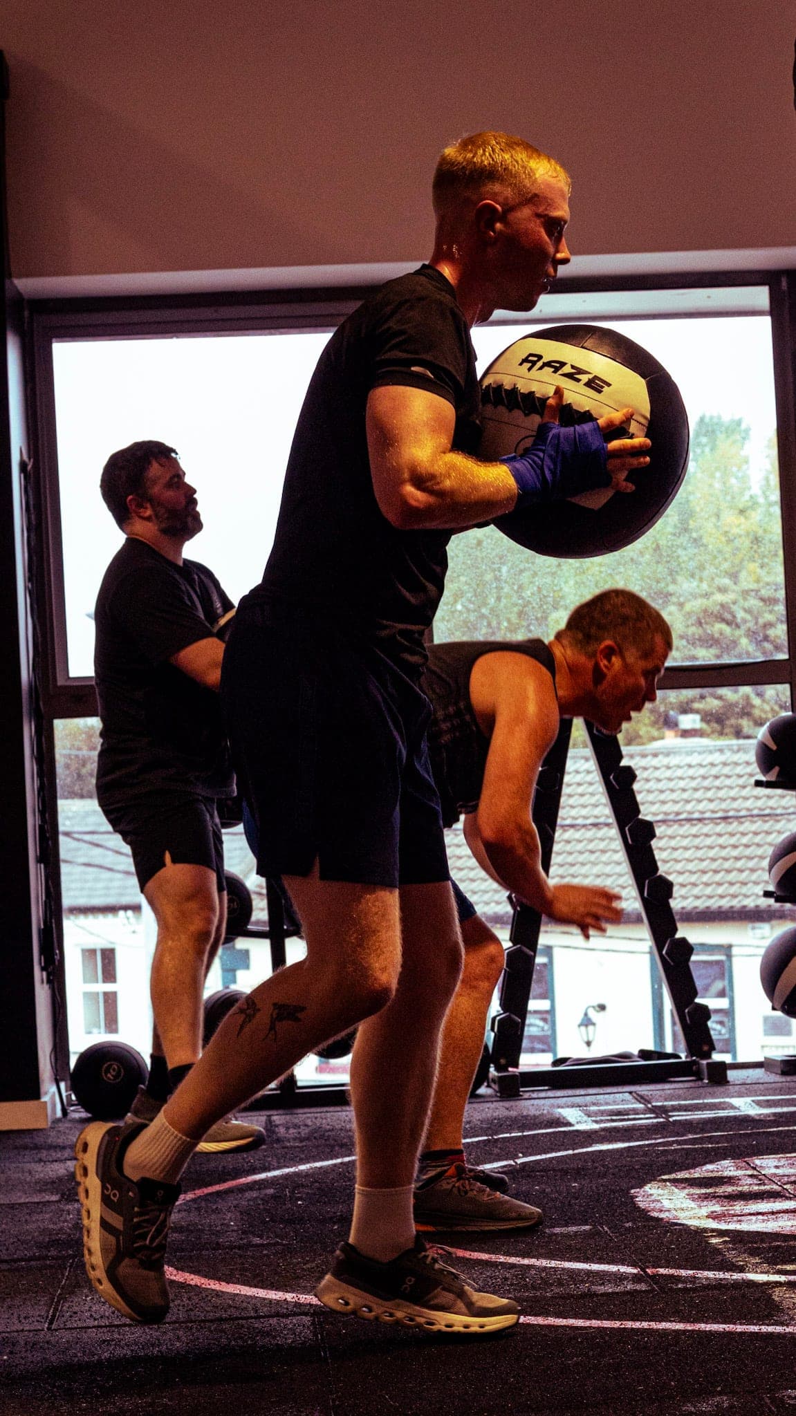 A member carrying a medicine ball during a conditioning circuit