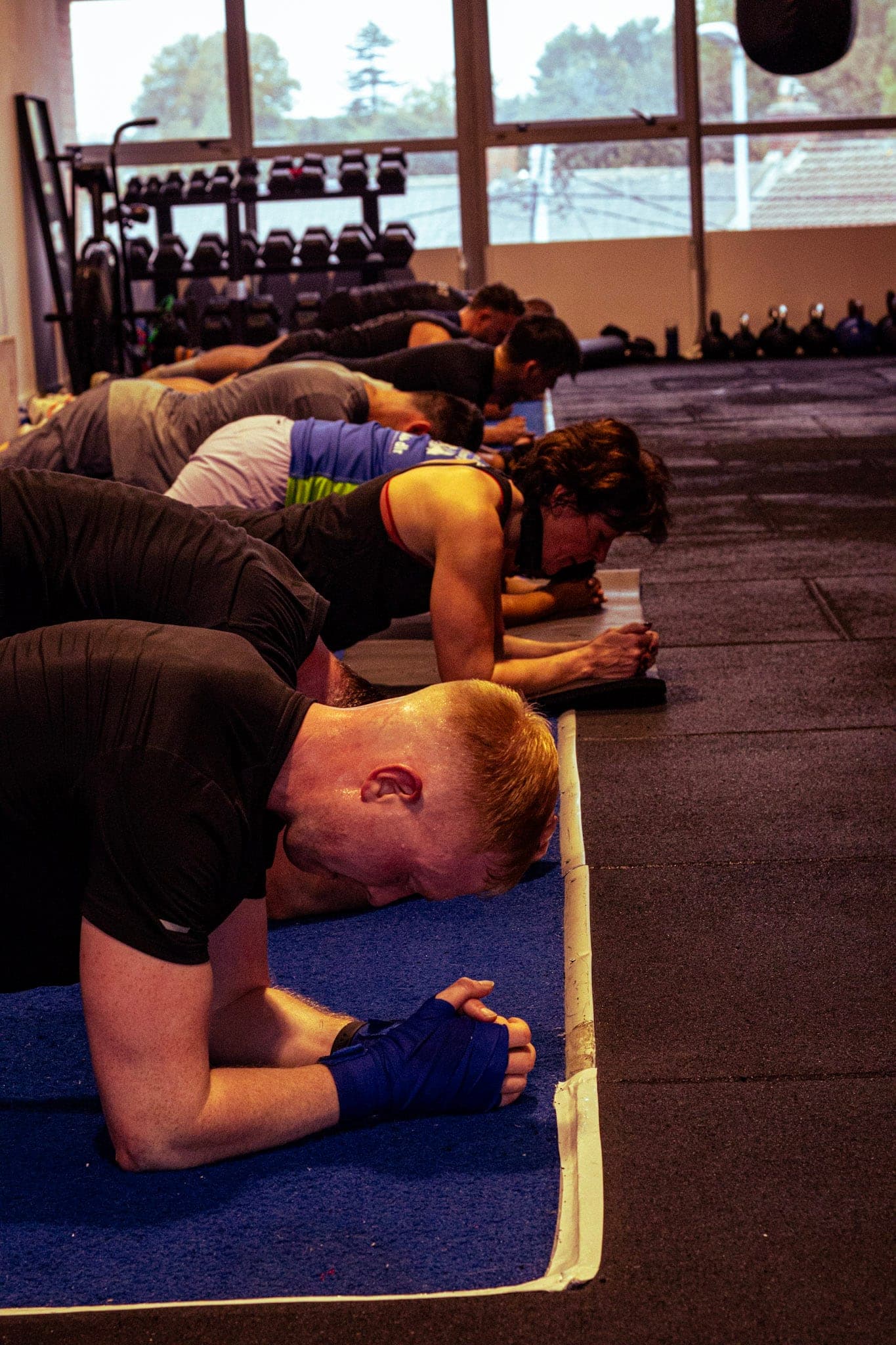 Members holding a plank during a conditioning finisher