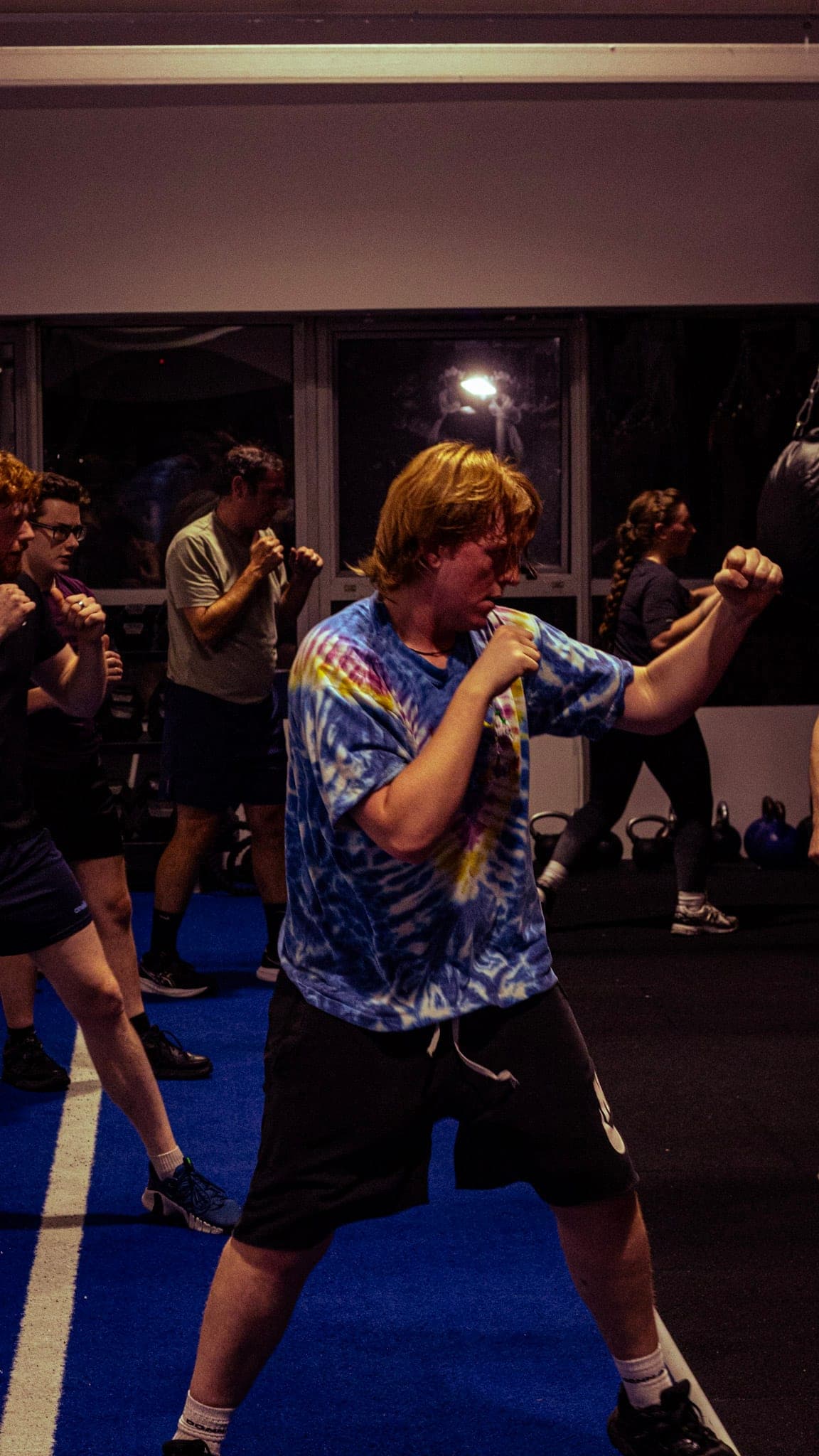 Members shadow boxing during an evening class