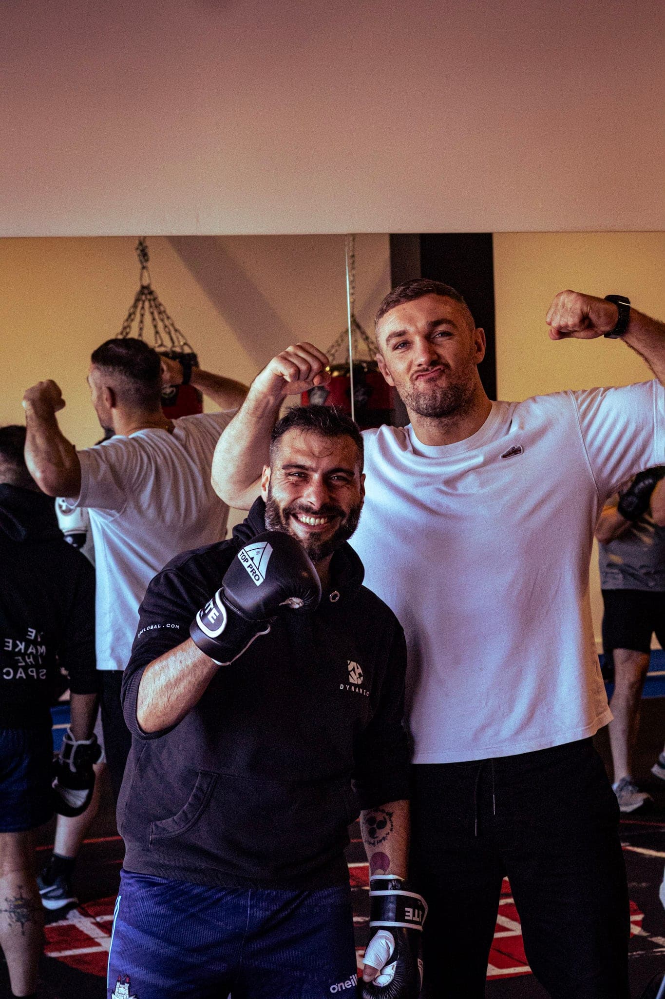 Two members posing for the camera after a session