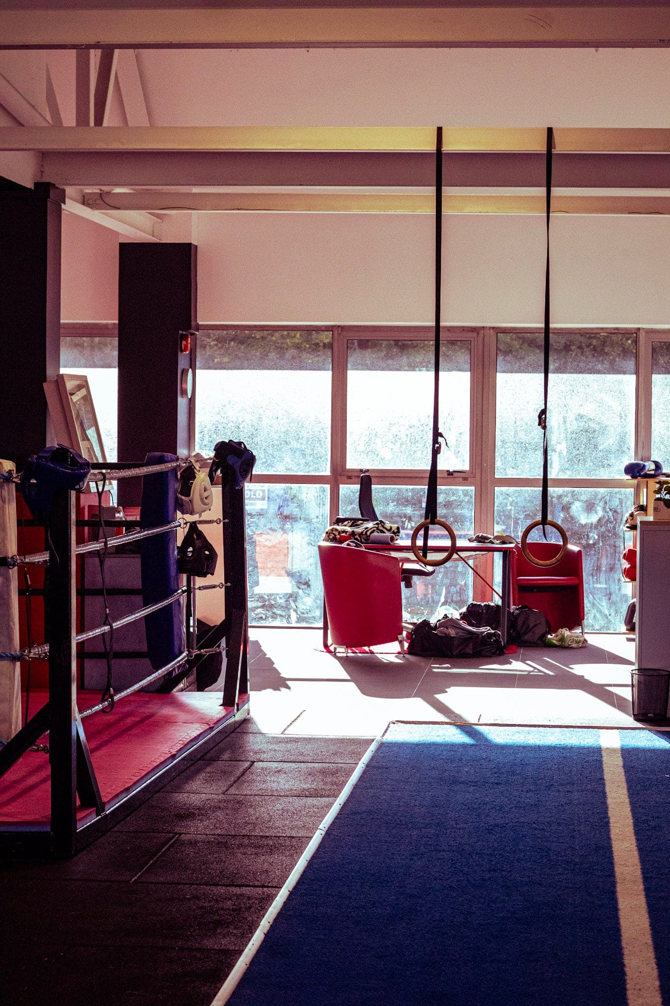 Tough Glove gym training area with the boxing ring and gymnastic rings