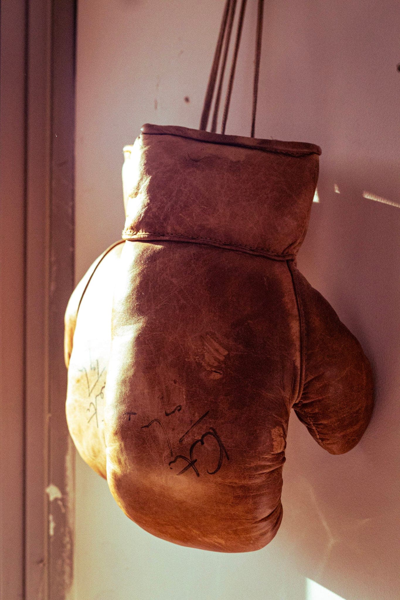 A vintage leather boxing glove hanging on the wall