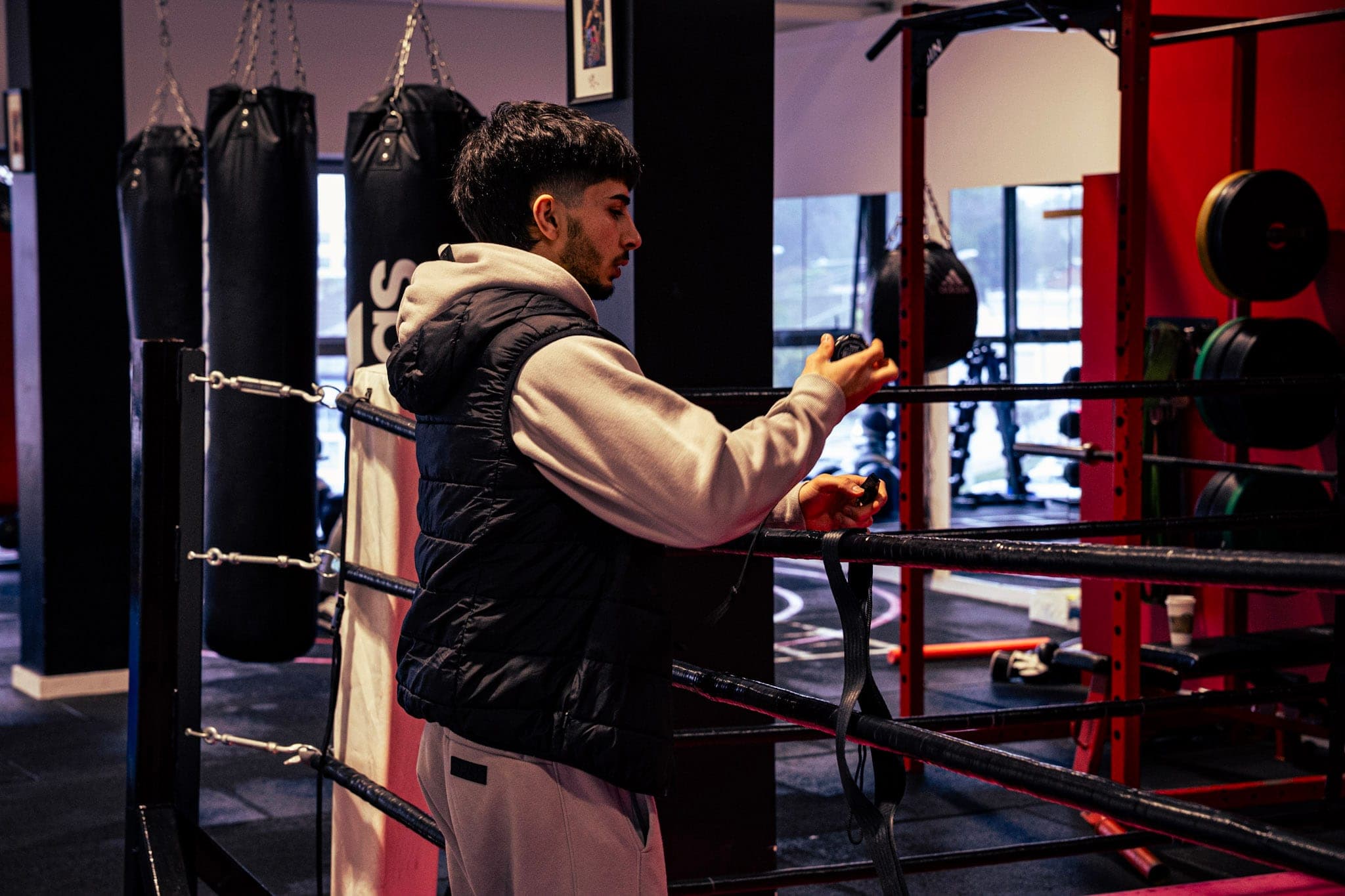 A member training beside the ring in the red corner of the gym