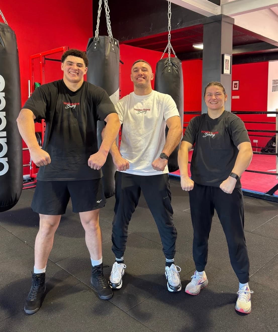 Tony Browne, centre, with Adam Olaniyan and Katie Taylor in Tough Glove Boxing T-shirts in front of the heavy bags